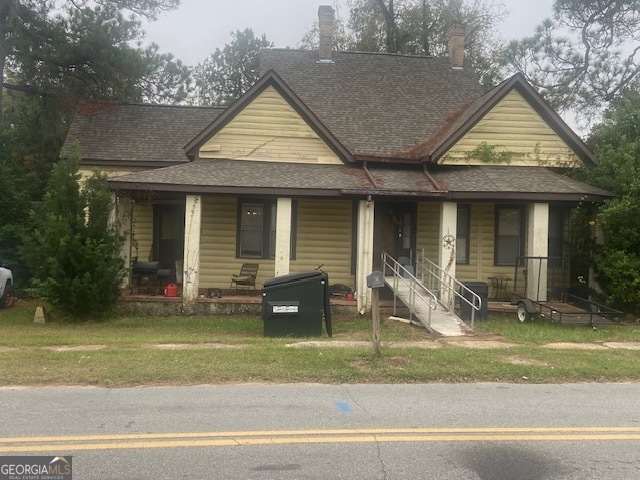 a front view of a house with a yard and porch