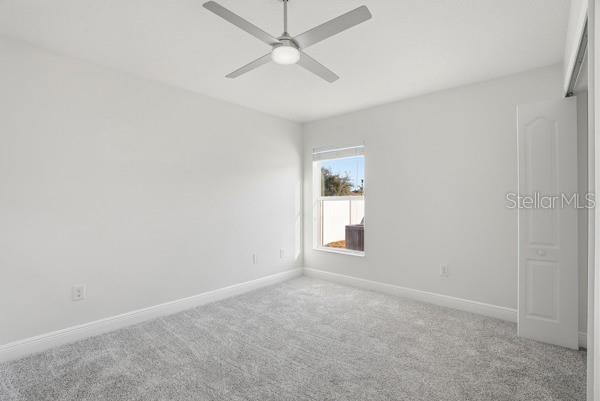 10120 Ives Loop Hudson, FL 34667 - Photo 16 of 23 an empty room with a empty space and a ceiling fan