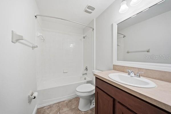 10120 Ives Loop Hudson, FL 34667 - Photo 18 of 23 a bathroom with a granite countertop sink toilet a shower and a mirror