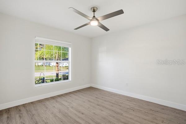 10120 Ives Loop Hudson, FL 34667 - Photo 19 of 23 wooden floor in an empty room with a window