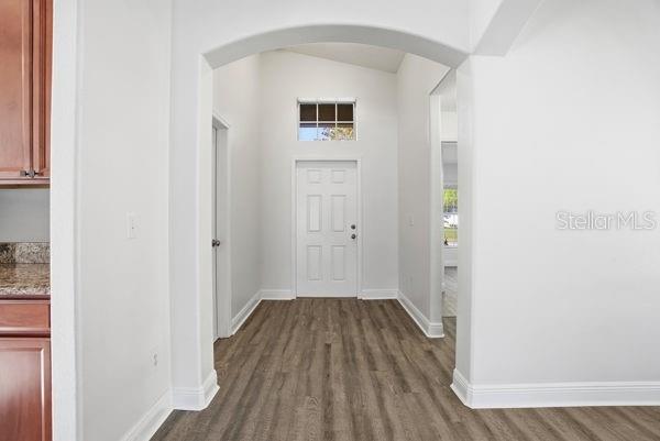10120 Ives Loop Hudson, FL 34667 - Photo 3 of 23 a view of a hallway with wooden floor