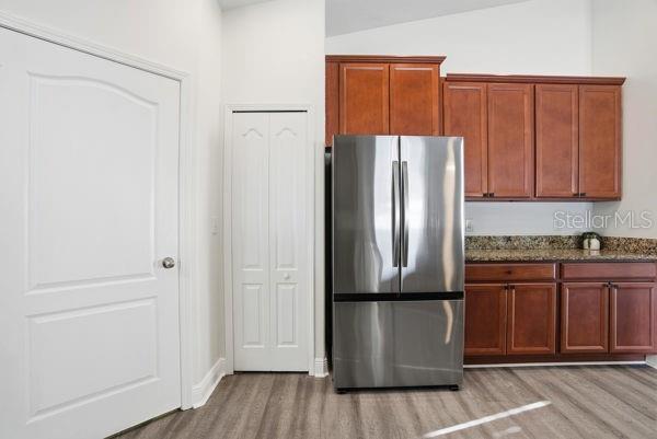 10120 Ives Loop Hudson, FL 34667 - Photo 6 of 23 a kitchen with a refrigerator cabinet and a sink