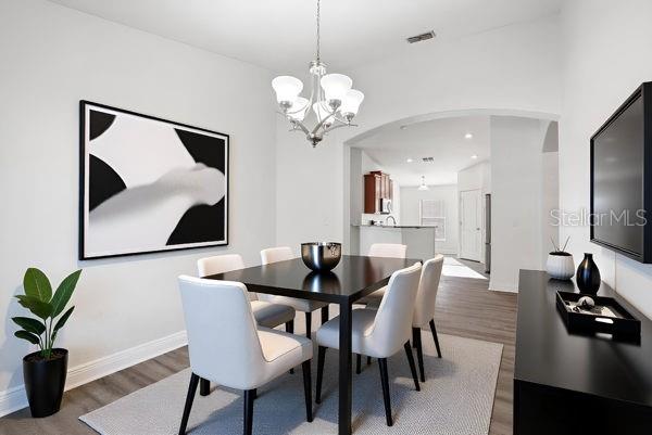 10120 Ives Loop Hudson, FL 34667 - Photo 7 of 23 a view of a dining room with furniture and wooden floor