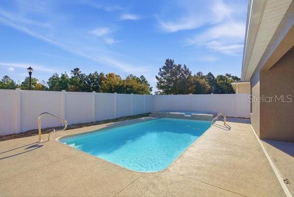 10120 Ives Loop Hudson, FL 34667 - Photo 9 of 23 a view of a swimming pool and a back yard