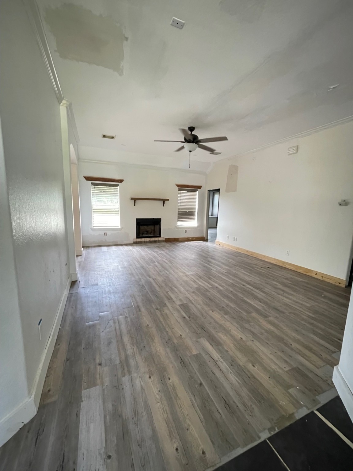 7599 County Road 3 Sweeny, TX 77480 - Photo 4 of 9 wooden floor in an empty room with a fireplace