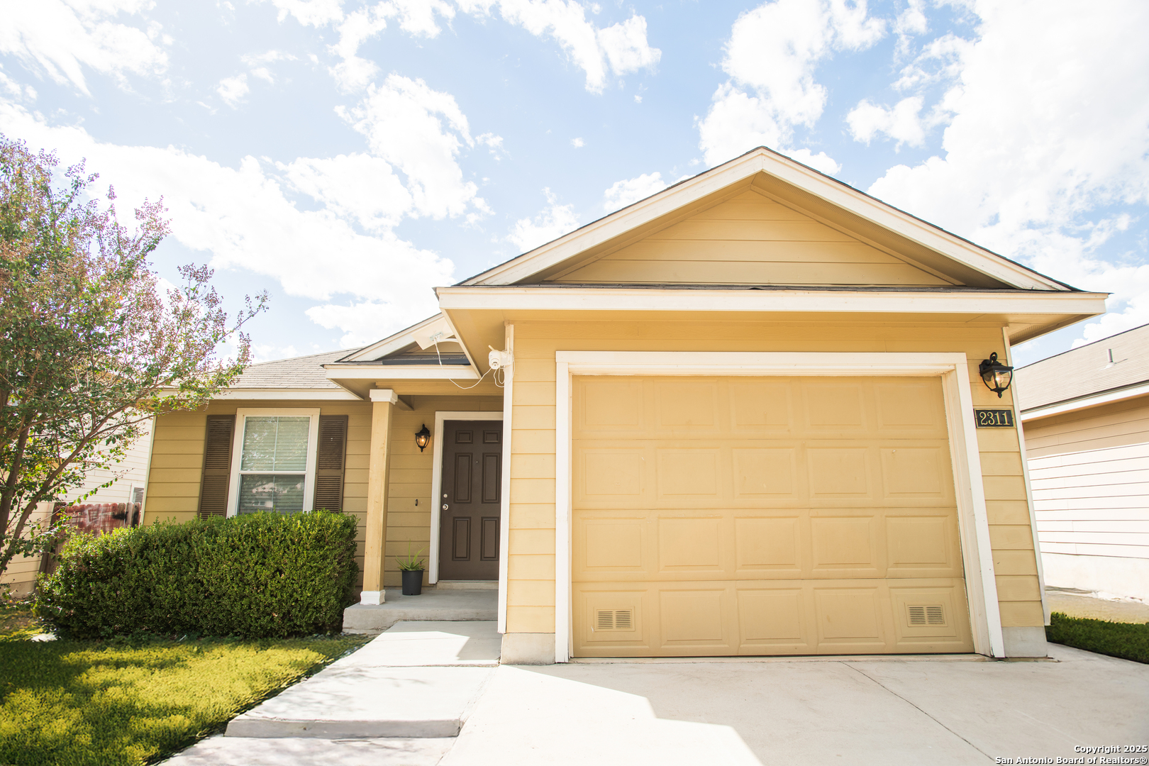 a front view of a house with a yard