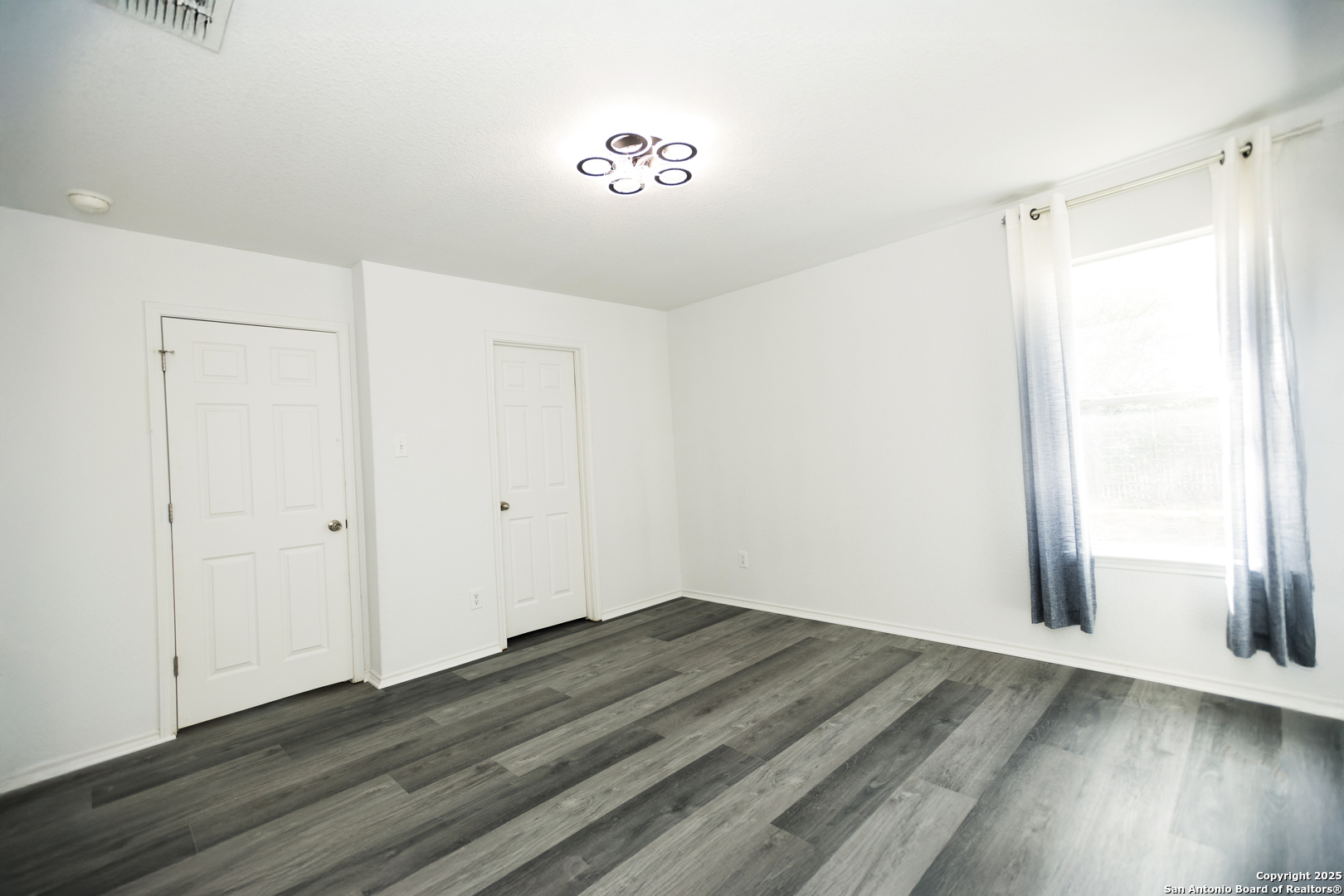 2311 Cloudbait View Converse, TX 78109 - Photo 11 of 20 a view of a room with wooden floor and a window