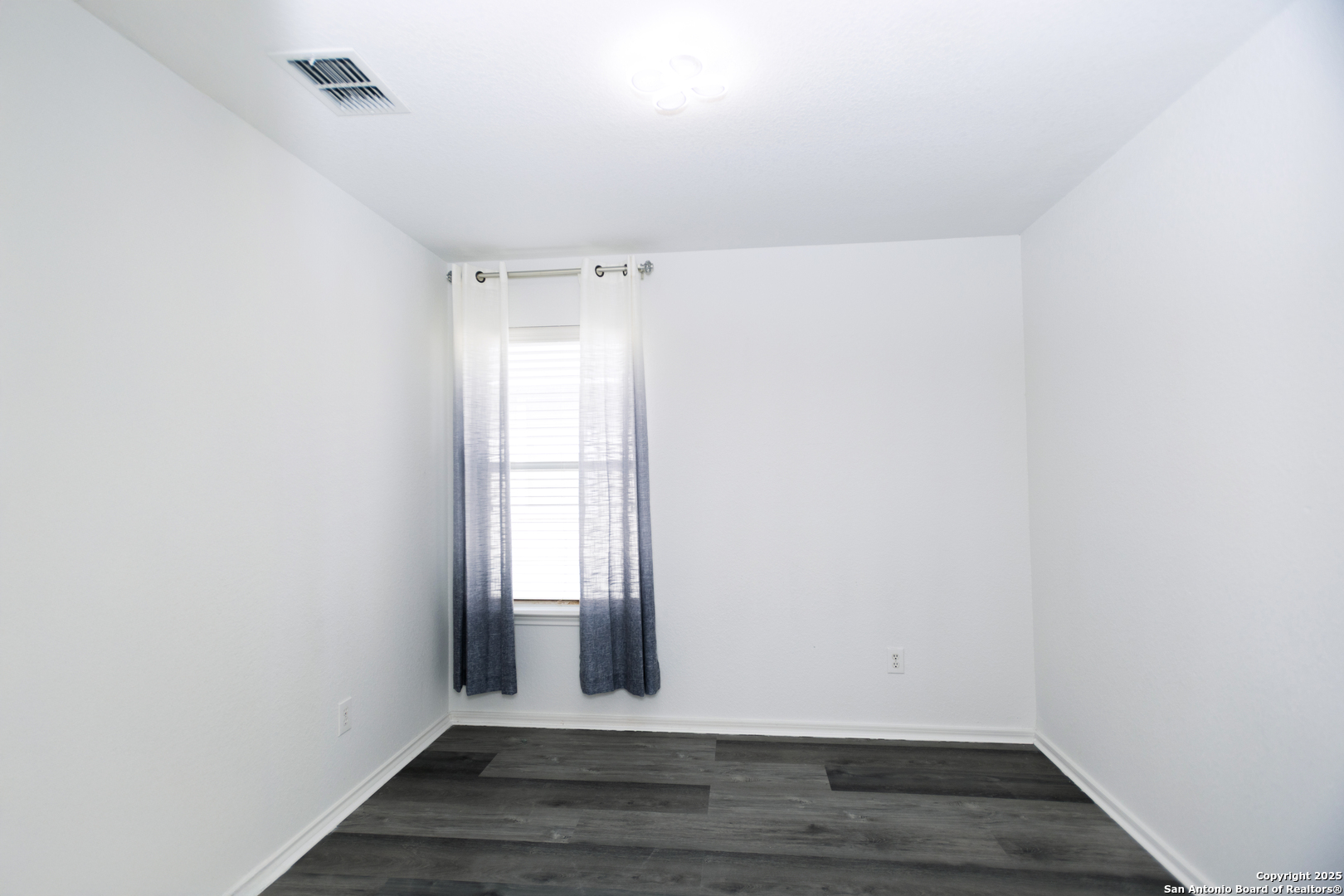 2311 Cloudbait View Converse, TX 78109 - Photo 15 of 20 a view of an empty room with wooden floor and a window