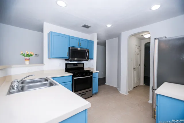 a kitchen that has a sink and a stove in it