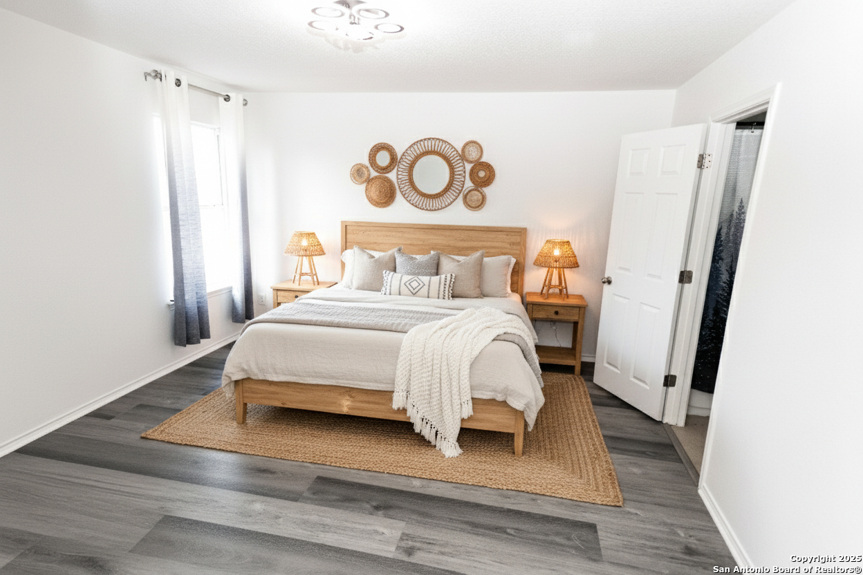 2311 Cloudbait View Converse, TX 78109 - Photo 10 of 20 a bed sitting in a bedroom next to a bathroom