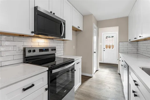 a kitchen with a stove and a microwave