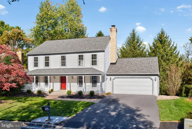 a front view of a house with a garden and plants