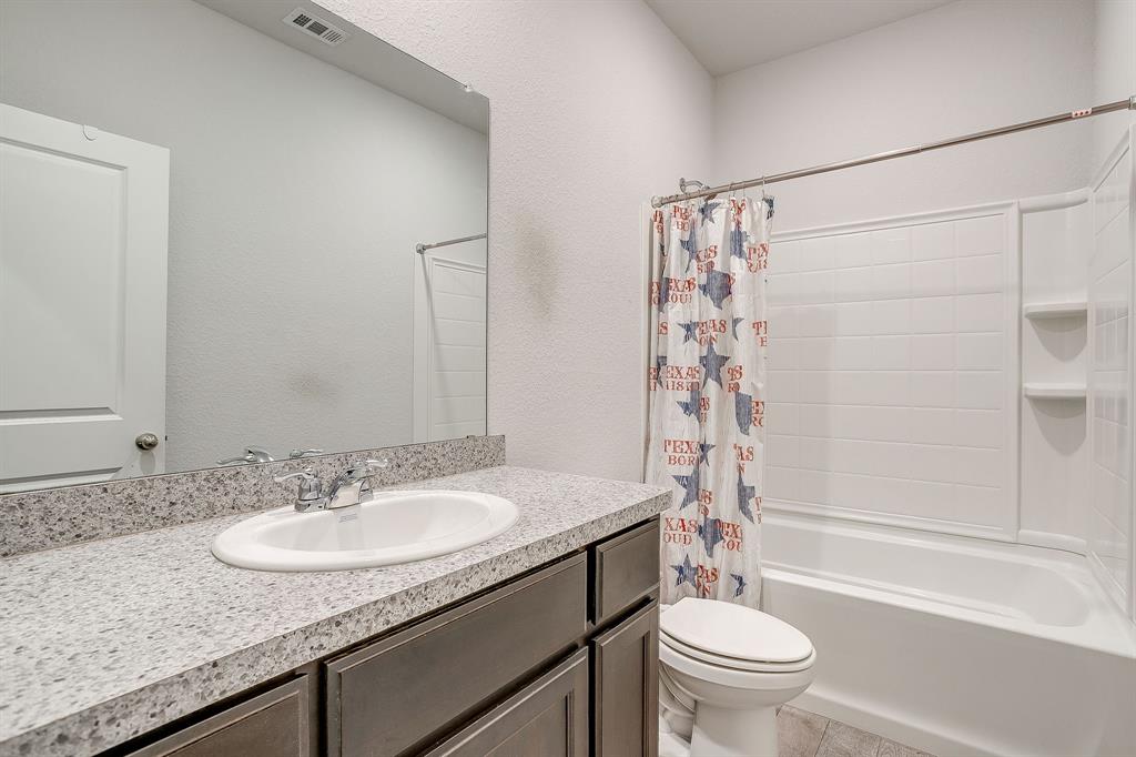 2313 Stallings Road Fort Worth, TX 76108 - Photo 20 of 30 a bathroom with a granite countertop sink toilet and shower