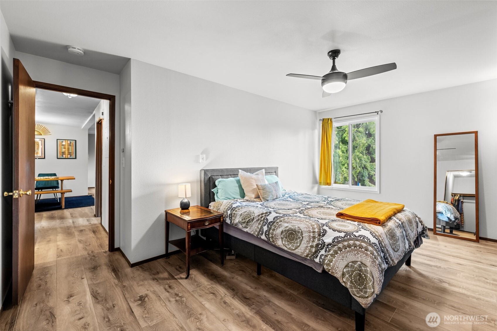 8516 196th Street Southwest, Unit 311 Edmonds, WA 98026 - Photo 15 of 28 a bedroom with a bed and a chandelier