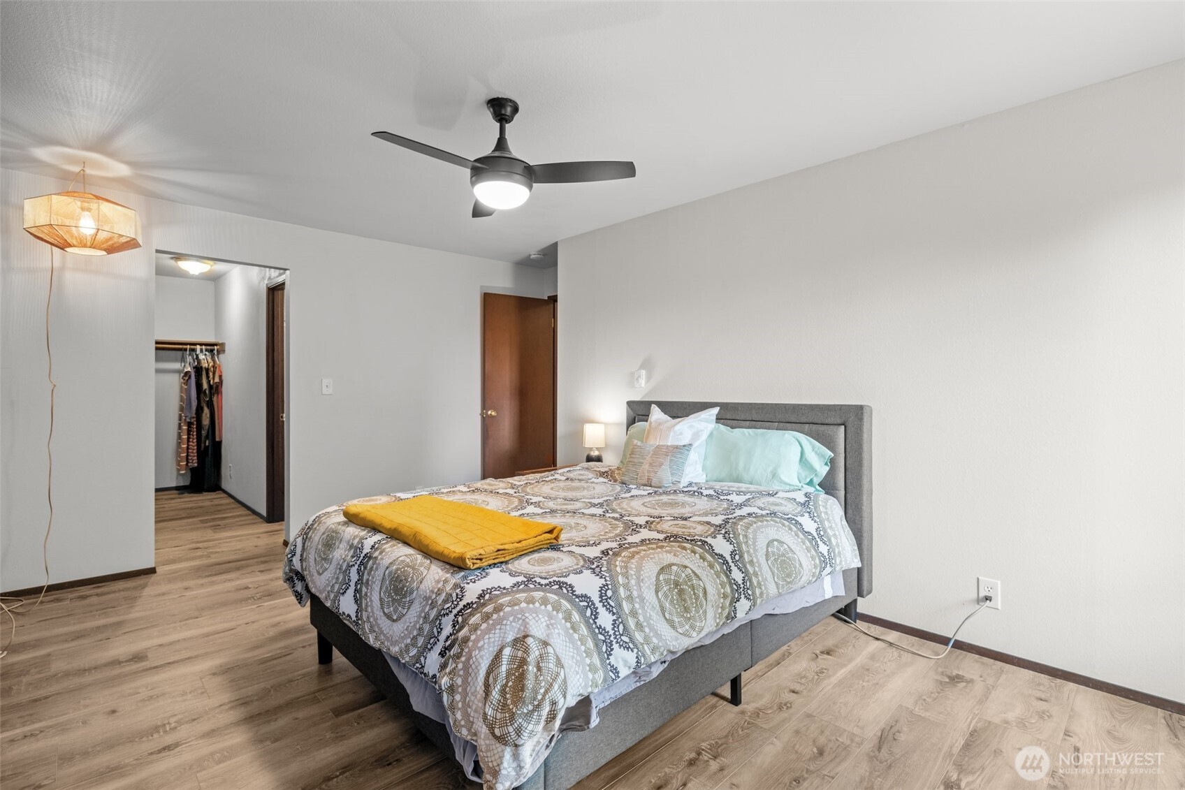 8516 196th Street Southwest, Unit 311 Edmonds, WA 98026 - Photo 16 of 28 a bedroom with a bed and a chandelier