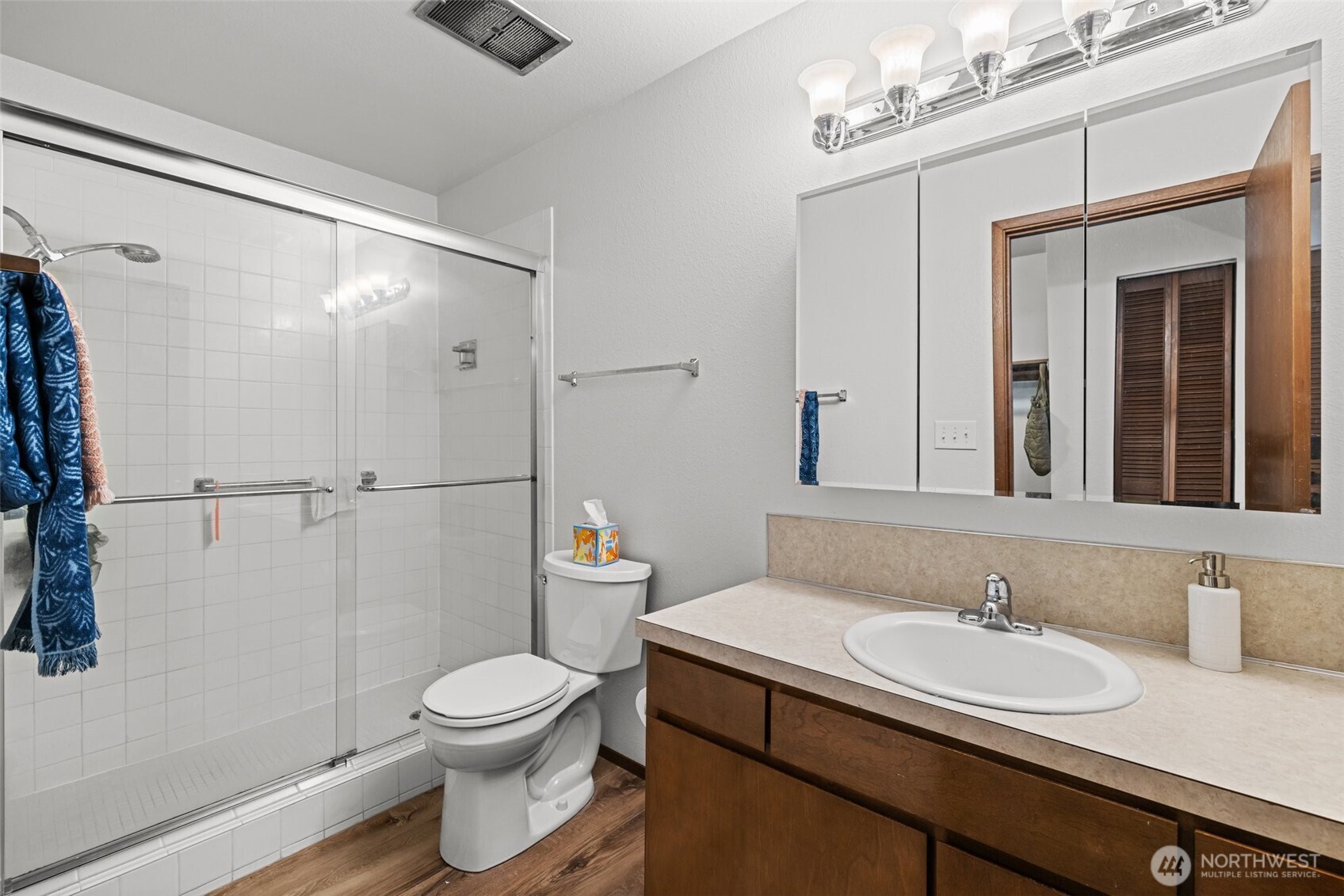 8516 196th Street Southwest, Unit 311 Edmonds, WA 98026 - Photo 18 of 28 a bathroom with a granite countertop sink toilet a mirror and shower