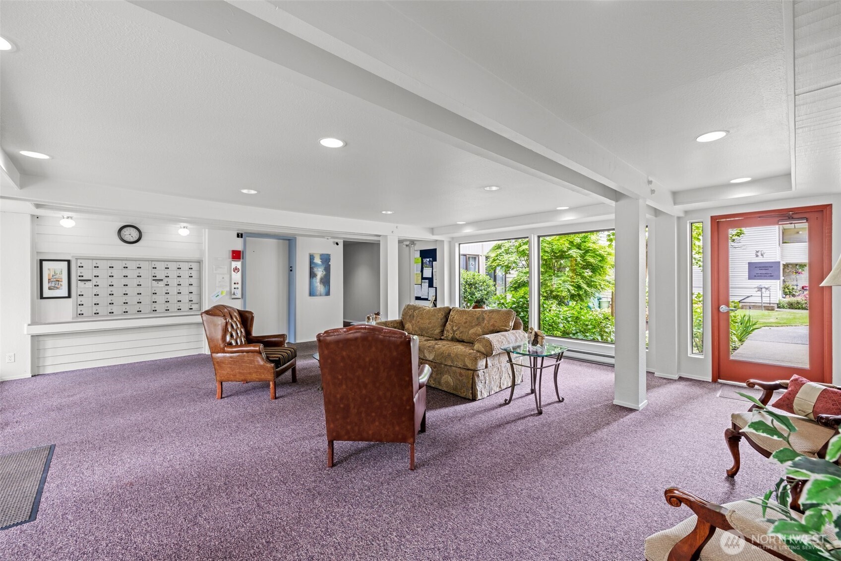 8516 196th Street Southwest, Unit 311 Edmonds, WA 98026 - Photo 27 of 28 a living room with furniture and a floor to ceiling window
