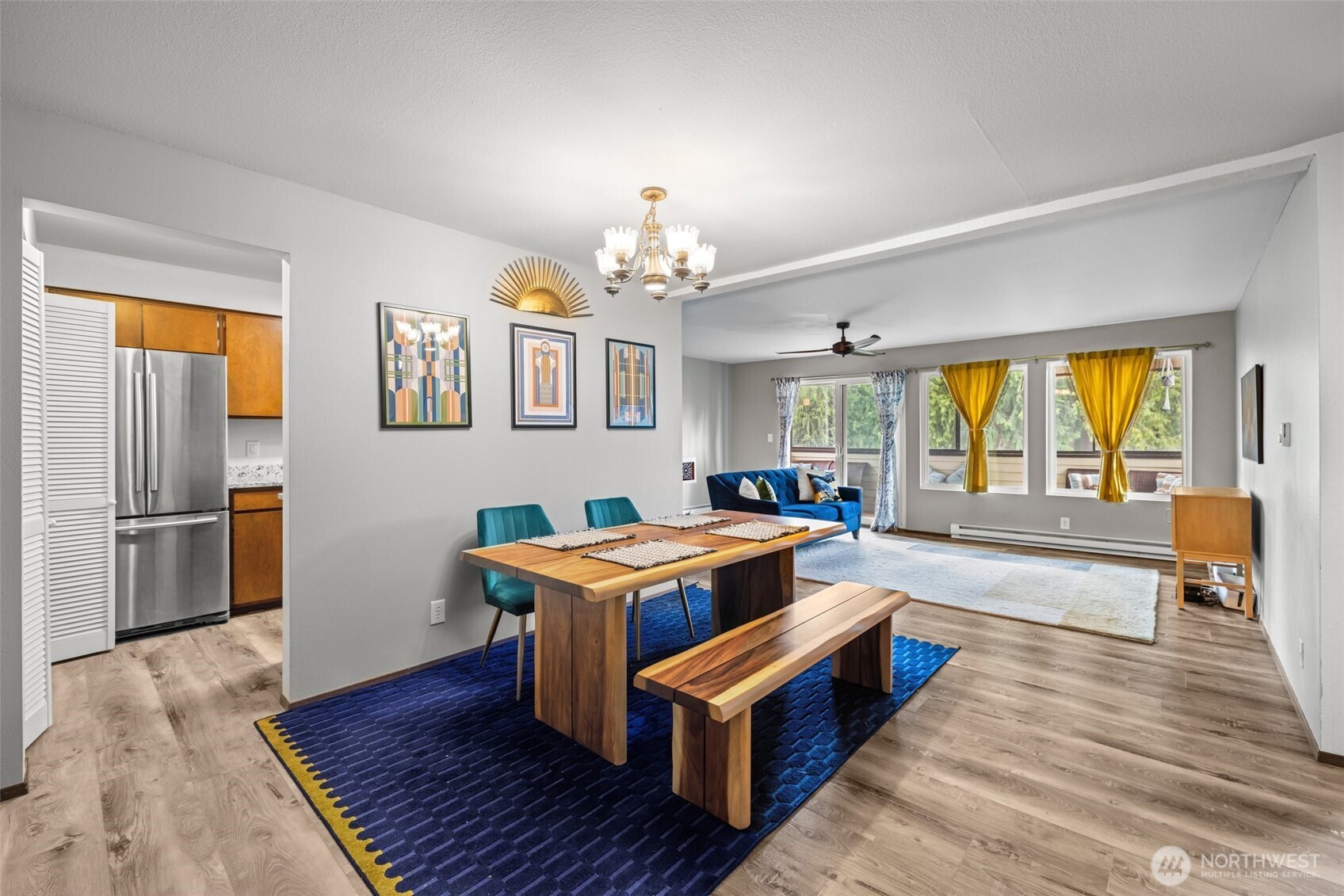 8516 196th Street Southwest, Unit 311 Edmonds, WA 98026 - Photo 4 of 28 a spacious bedroom with a bed and a chandelier