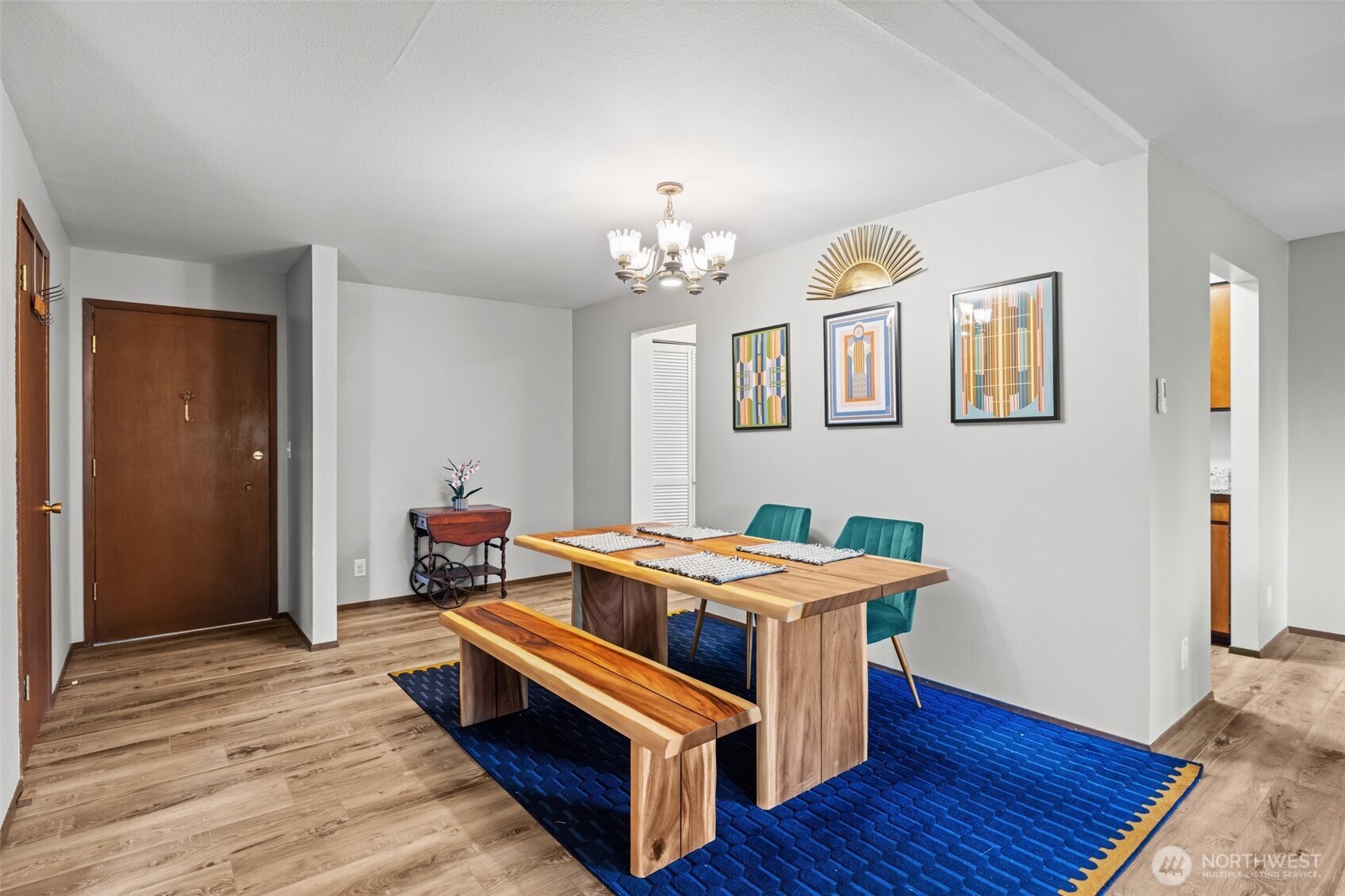 8516 196th Street Southwest, Unit 311 Edmonds, WA 98026 - Photo 6 of 28 a bed room with a bed and a chandelier