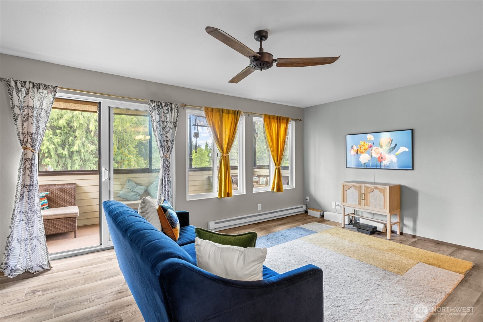8516 196th Street Southwest, Unit 311 Edmonds, WA 98026 - Photo 9 of 28 a living room with furniture and a flat screen tv with wooden floor