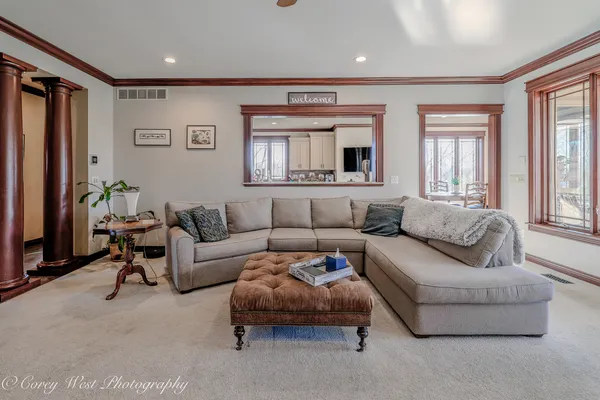 a spacious bedroom with a bed and a chandelier
