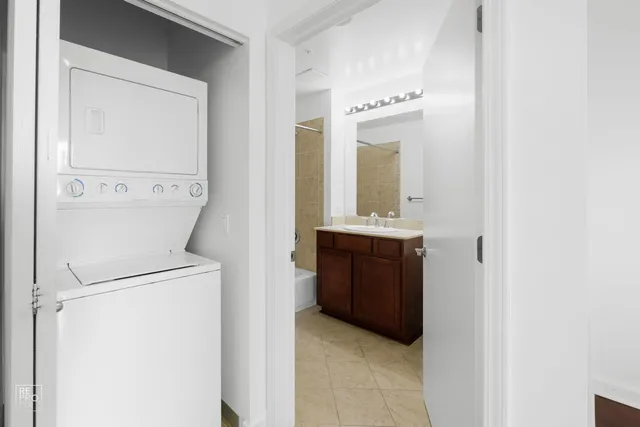 a bathroom with a bathtub sink vanity and mirror
