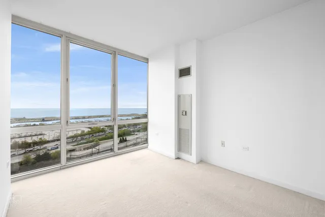 an empty room with large windows