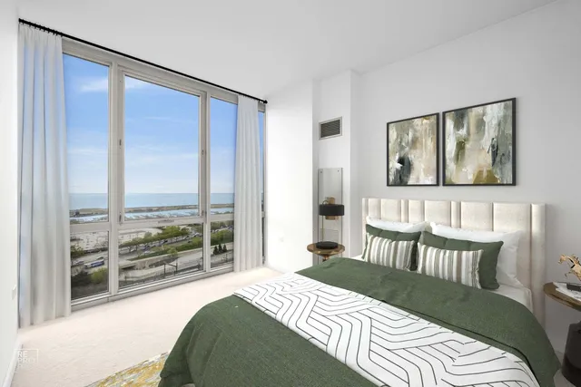 a bedroom with a bed and a large window