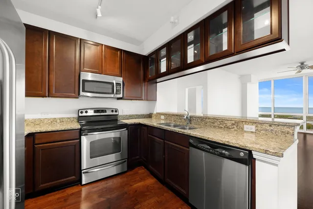 a kitchen with stainless steel appliances granite countertop a stove and a sink