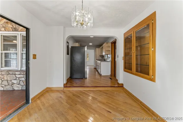 a view of a room with wooden floor and windows