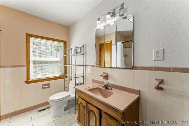 a bathroom with a sink toilet and mirror