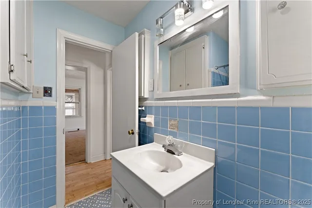 a bathroom with a sink shower and a mirror