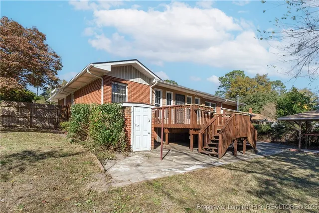 a front view of house with deck outdoor seating and barbeque oven