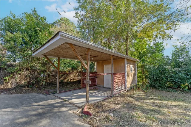 an aerial view of a house with pool and trees