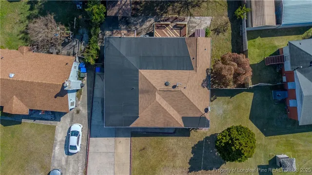 an aerial view of a house with a yard