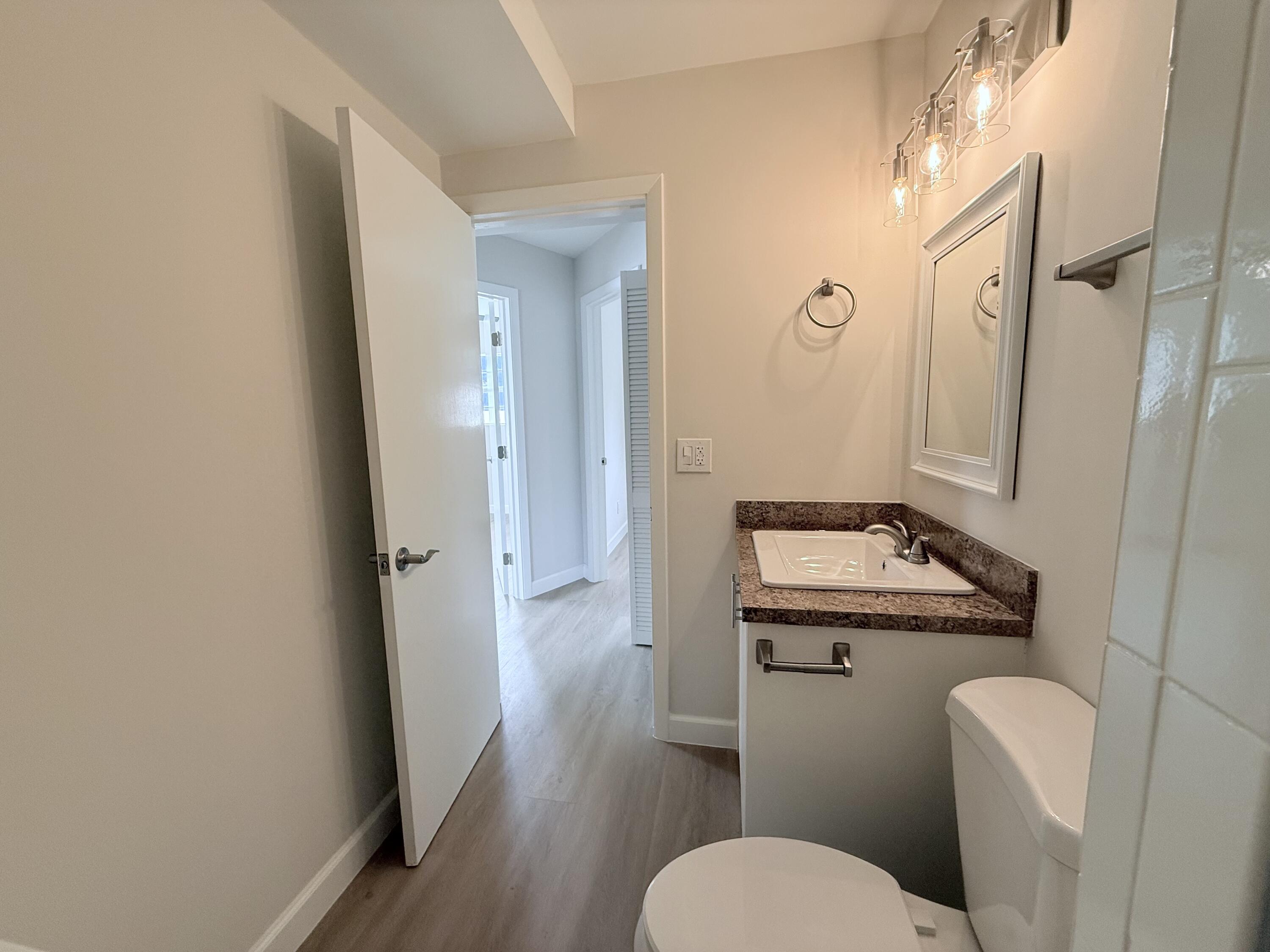 2401 Patterson Avenue, Unit 101 Key West, FL 33040 - Photo 14 of 26 a bathroom with a granite countertop toilet sink and shower