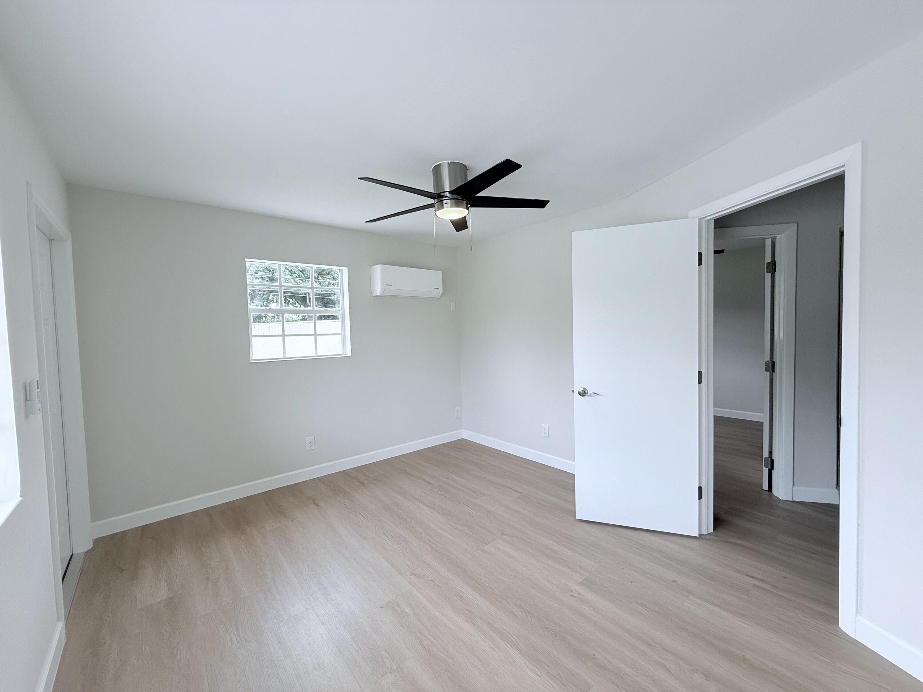2401 Patterson Avenue, Unit 101 Key West, FL 33040 - Photo 17 of 26 an empty room with wooden floor and a ceiling fan