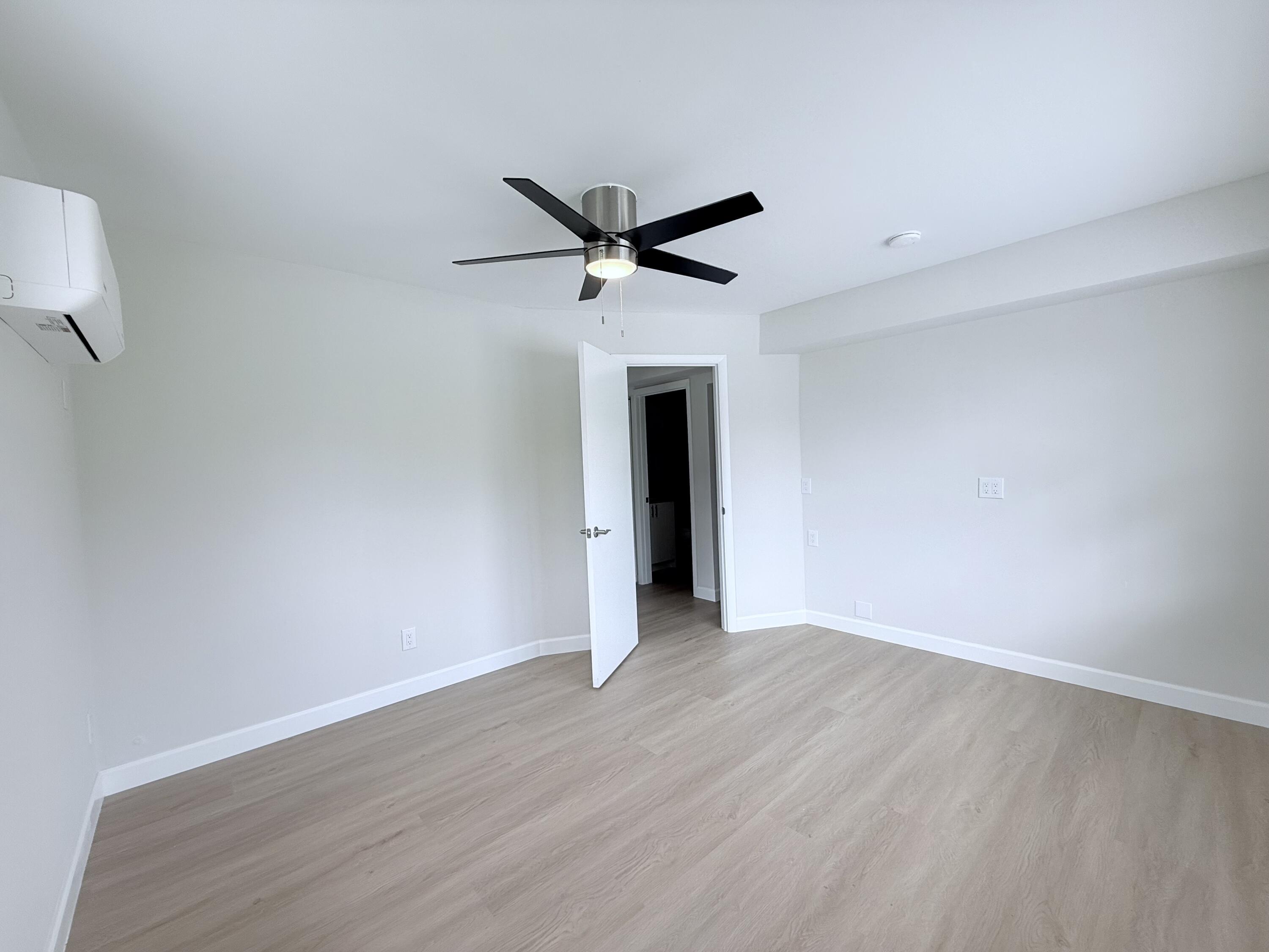 2401 Patterson Avenue, Unit 101 Key West, FL 33040 - Photo 18 of 26 a view of a livingroom with a ceiling fan and wooden floor
