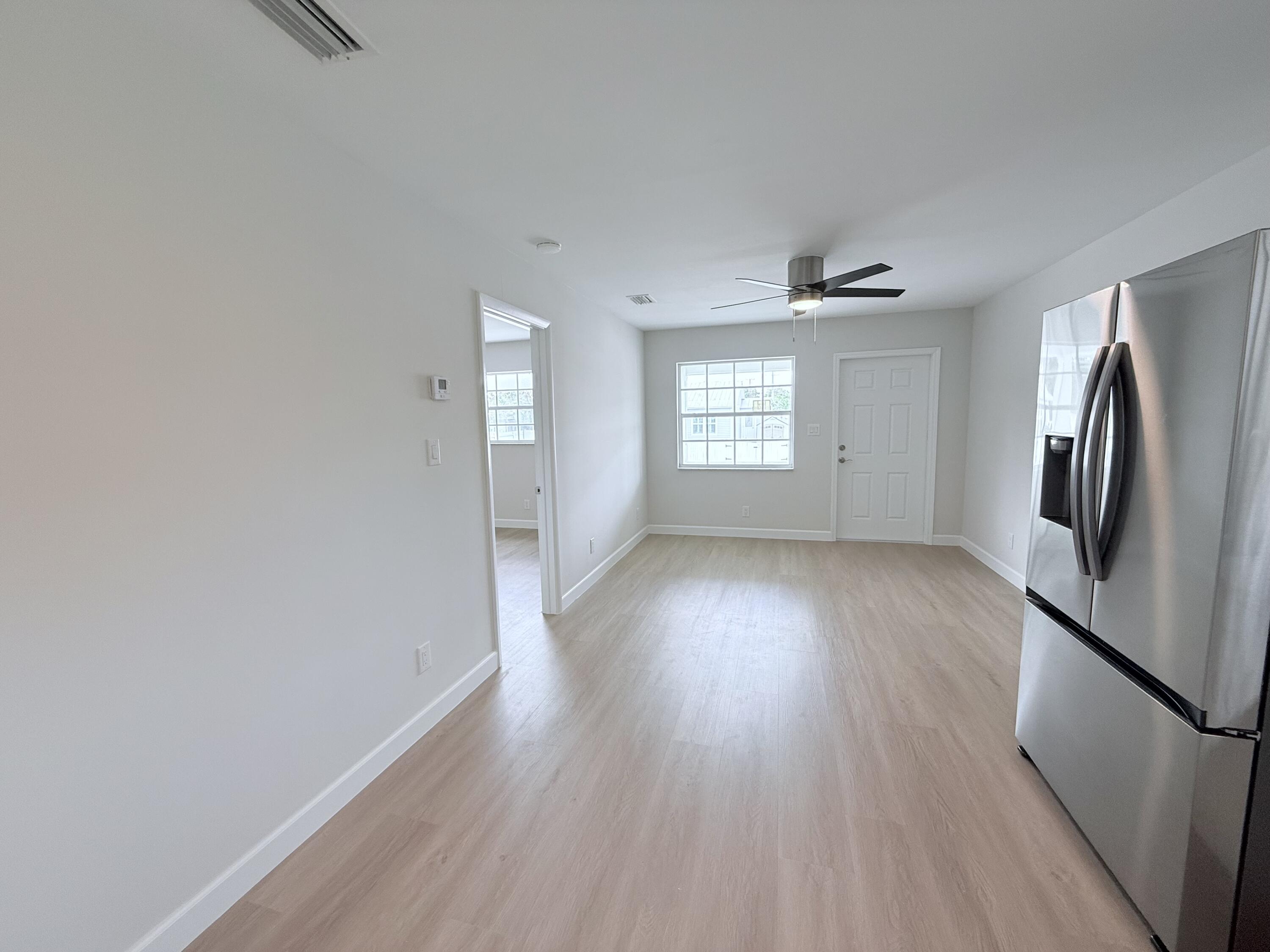 2401 Patterson Avenue, Unit 101 Key West, FL 33040 - Photo 4 of 26 a view of empty room with wooden floor and fan