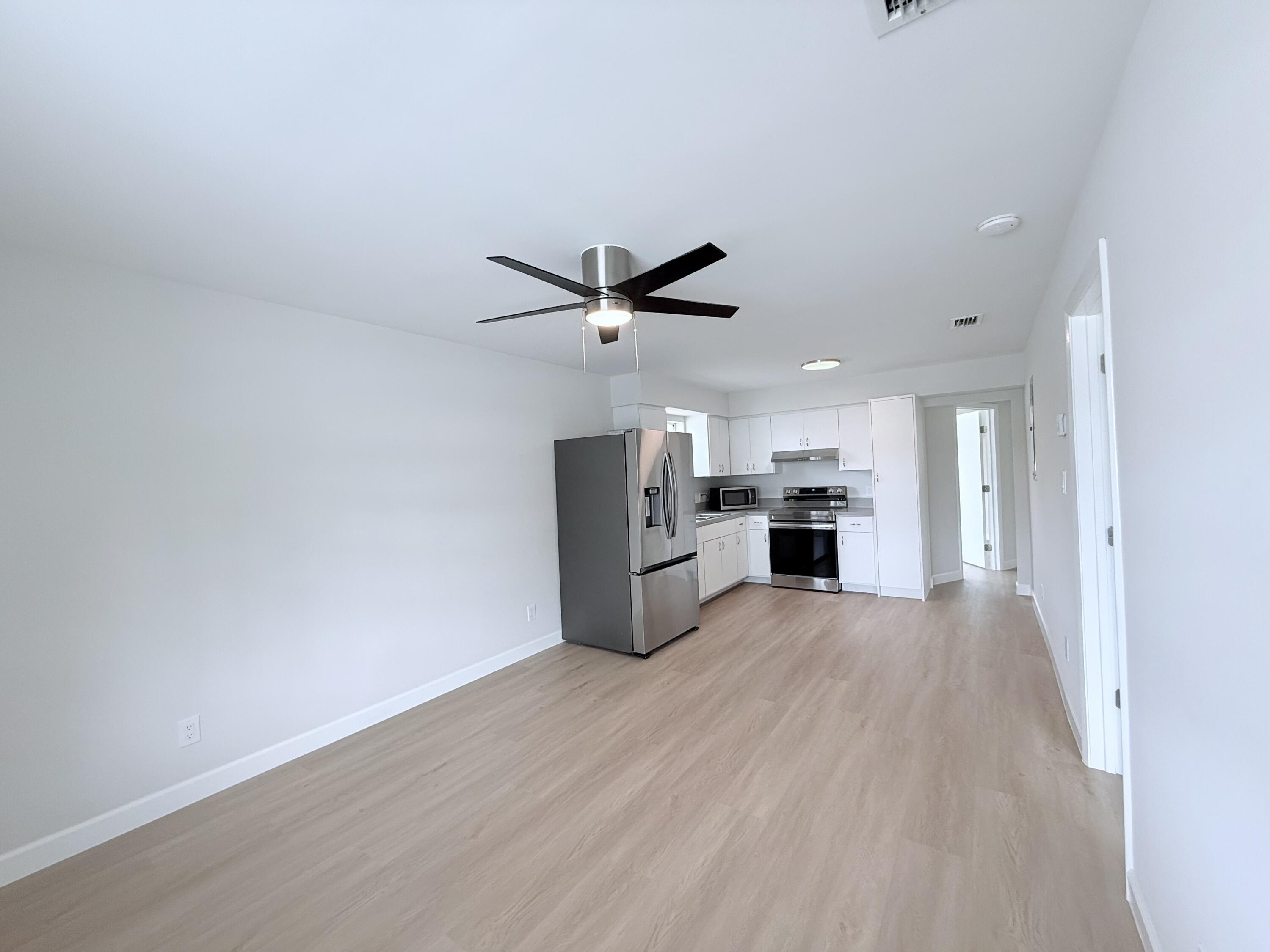 2401 Patterson Avenue, Unit 101 Key West, FL 33040 - Photo 5 of 26 a view of a kitchen with a sink and a refrigerator