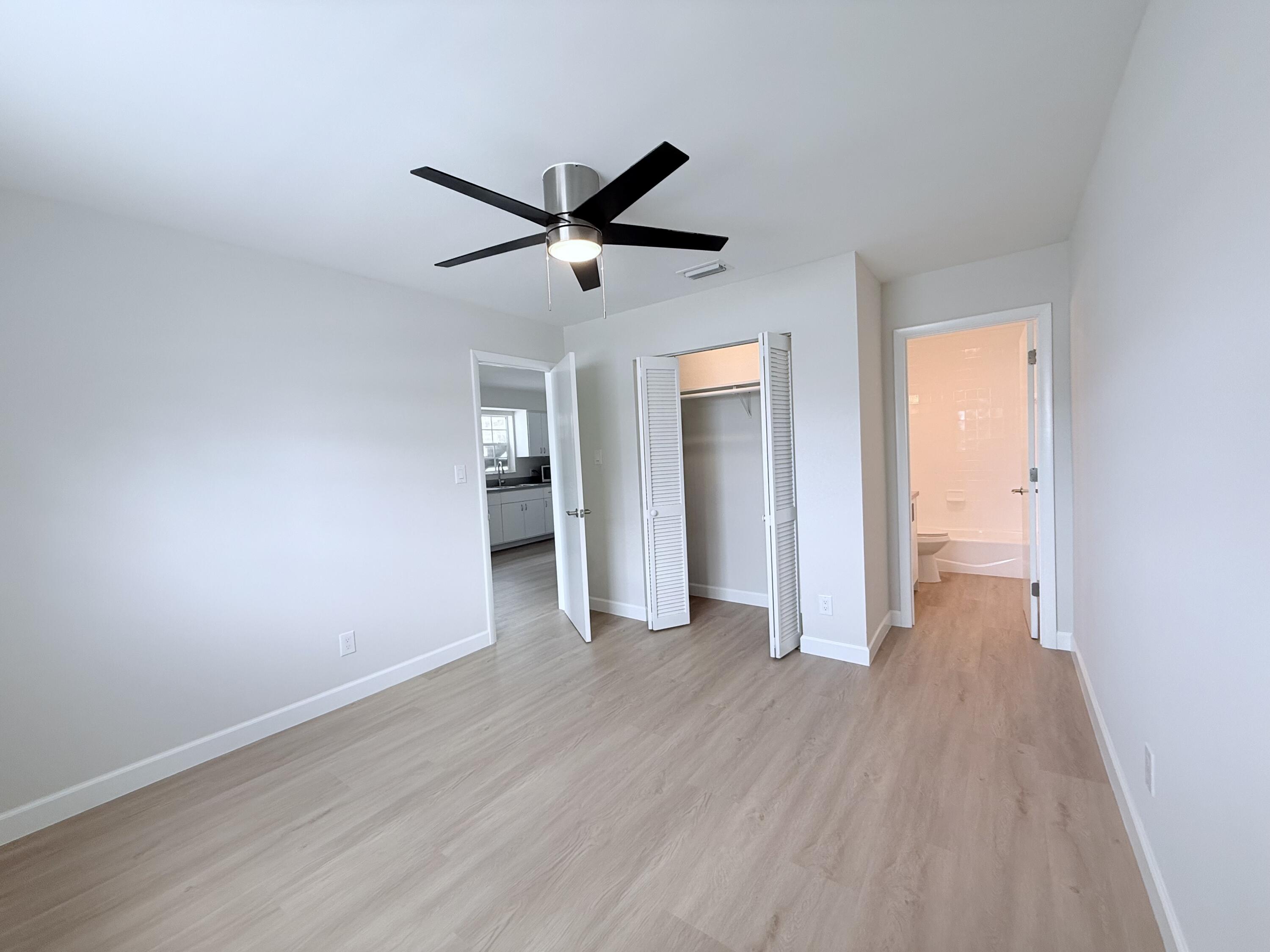 2401 Patterson Avenue, Unit 101 Key West, FL 33040 - Photo 7 of 26 a view of empty room with wooden floor and ceiling fan