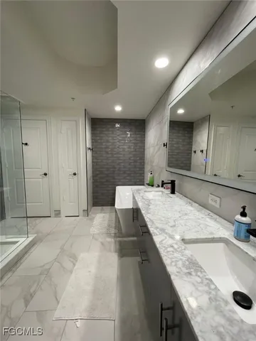 a large kitchen with kitchen island a sink stainless steel appliances and cabinets