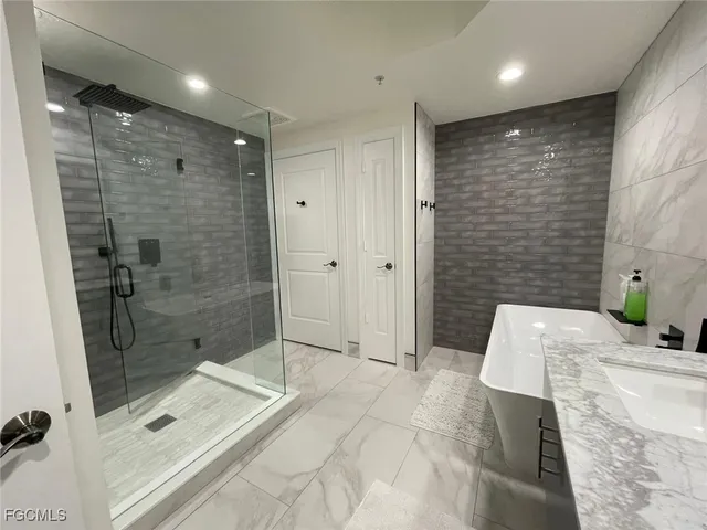 a bathroom with a shower and a sink a toilet