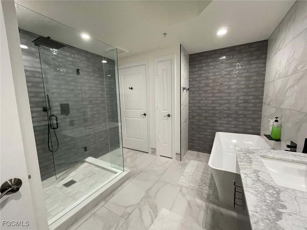 14380 Riva Del Lago Drive, Unit 1002 Fort Myers, FL 33907 - Photo 12 of 23 a bathroom with a shower and a sink a toilet