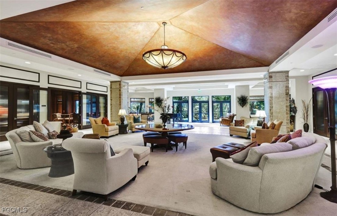 14380 Riva Del Lago Drive, Unit 1002 Fort Myers, FL 33907 - Photo 22 of 23 a living room with patio furniture and a large window