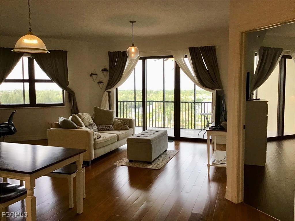 14380 Riva Del Lago Drive, Unit 1002 Fort Myers, FL 33907 - Photo 7 of 23 a living room with furniture and a large window