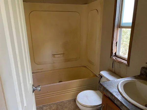 a bathroom with a toilet and shower