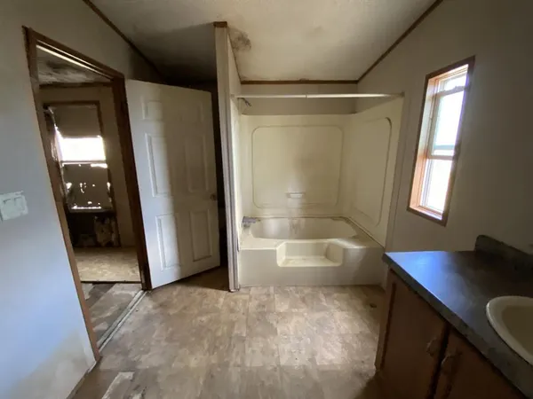 a bathroom with a tub and a mirror
