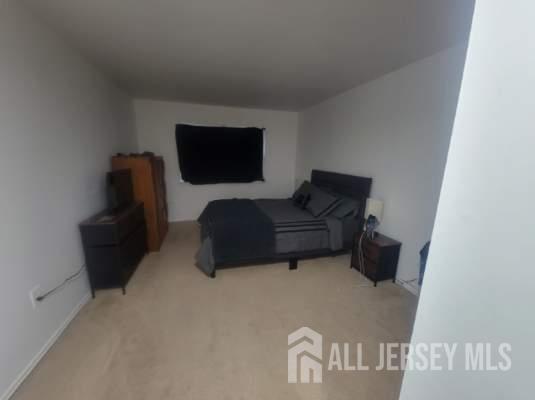 26 Judson Street, Unit 3 Edison, NJ 08837 - Photo 6 of 9 a living room with furniture and a flat screen tv