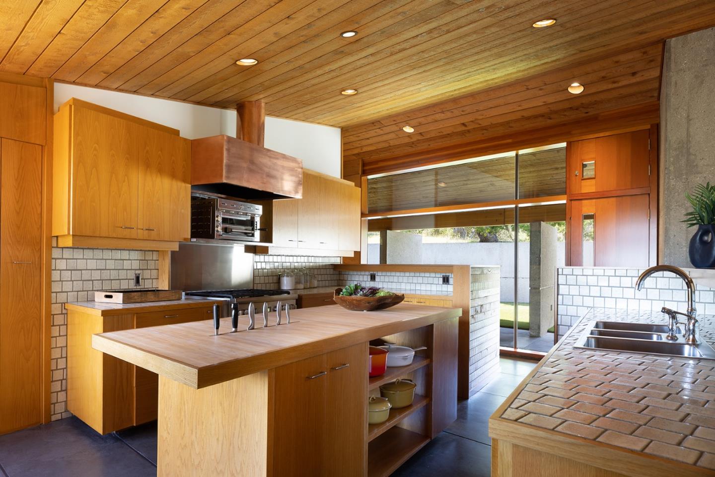 26225 Rinconada Drive Carmel Valley, CA 93924 - Photo 18 of 44 a kitchen with stainless steel appliances granite countertop a stove a sink and a refrigerator